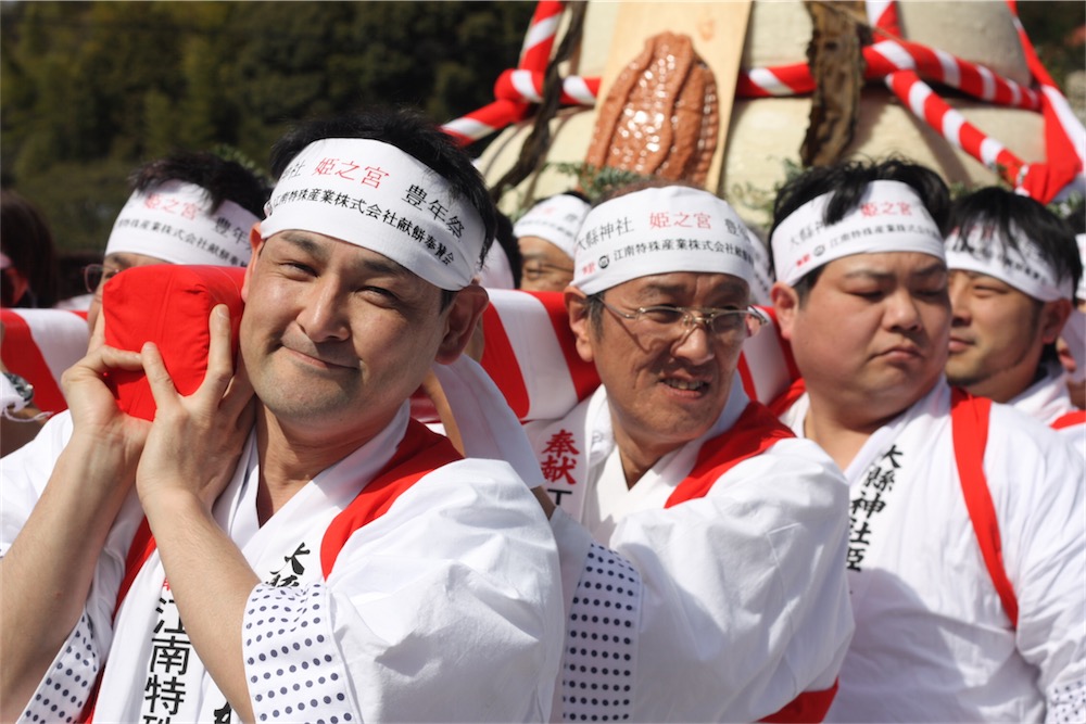 Men carry a labia icon on a palanquin at a Japanese fertility festival